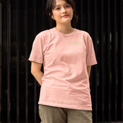 Plus-size Pink streetwear tee with “We Do Not Care Club” skull and cross-bat graphic, red roses and barbed wire detail – limited release