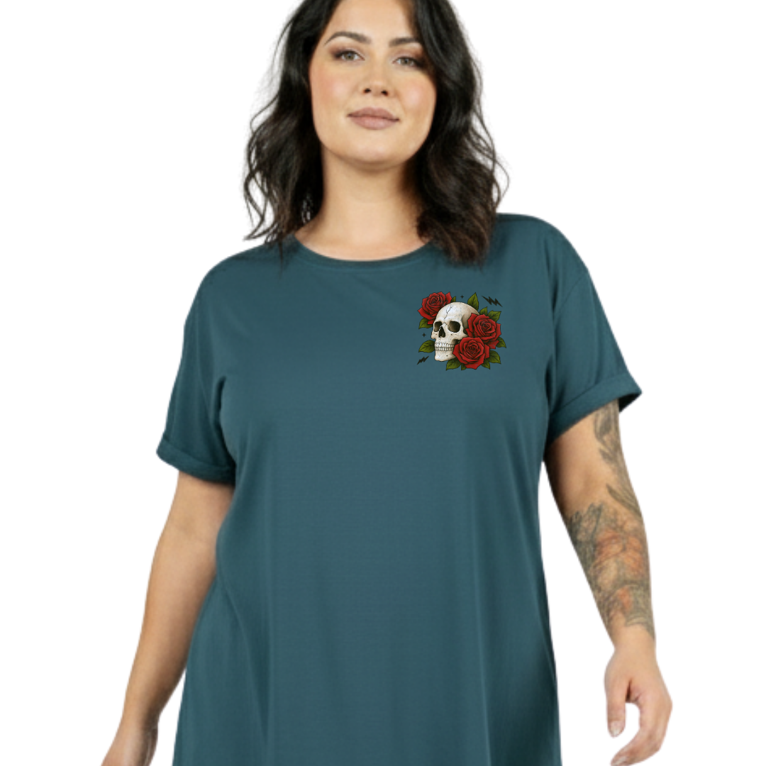 A woman wearing a teal short-sleeve t-shirt with a small chest graphic of a skull and red roses, set against a plain white background.