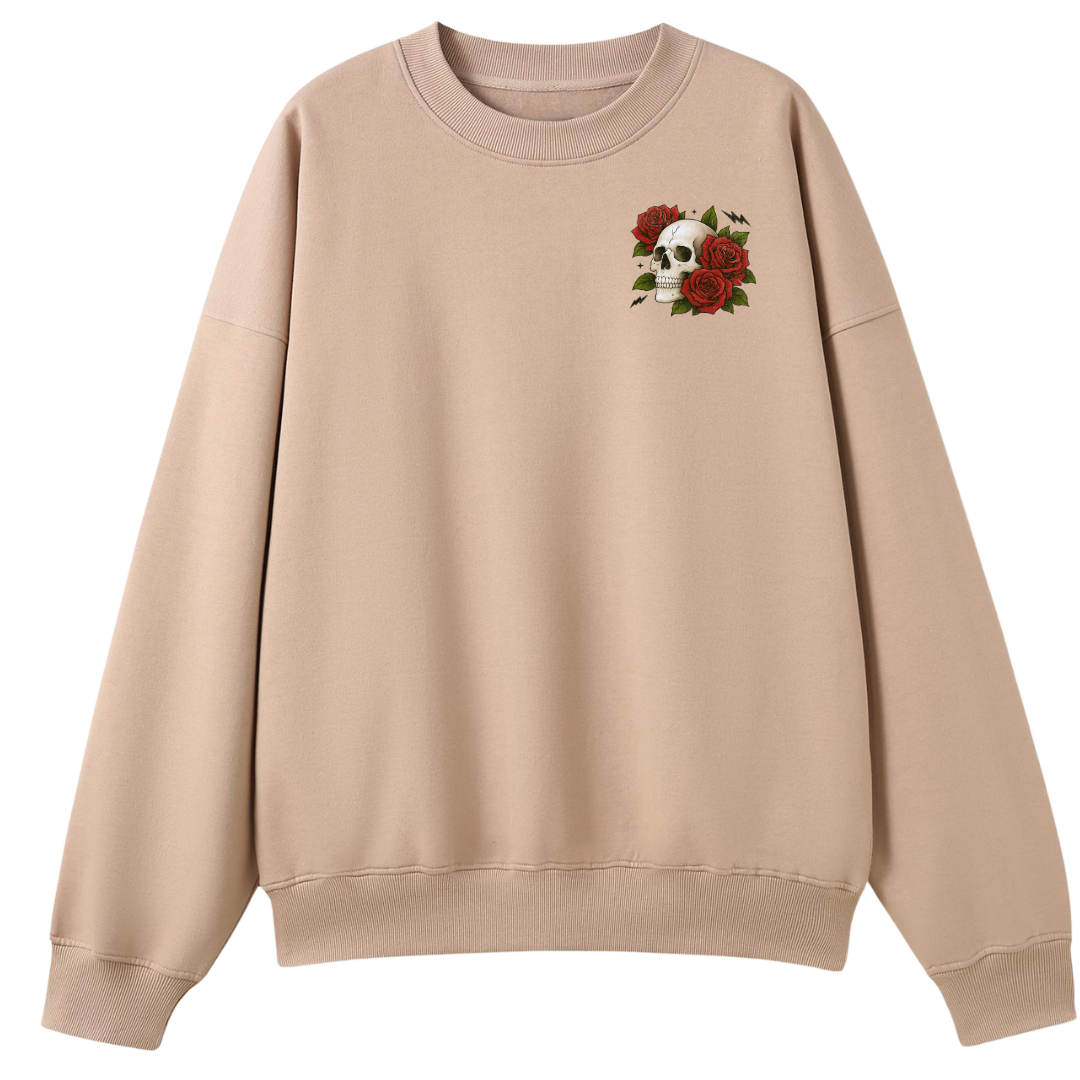 A beige crewneck sweatshirt featuring a small chest graphic of a white skull surrounded by red roses and green leaves, displayed on a solid white background.