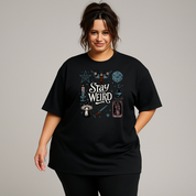Woman wearing black oversized graphic tee with Stay Weird witchy illustration back print, plus size Australian streetwear by Bae Bands