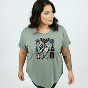 Front view of woman wearing slate green Stay Weird oversized tee, relaxed drop shoulder fit, plus size Australian streetwear by Bae Bands