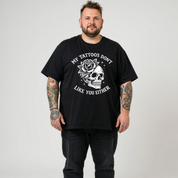Front view of a man wearing black My Tattoos Don't Like You Either oversized tee, relaxed drop shoulder fit, plus size Australian streetwear by Bae Bands
