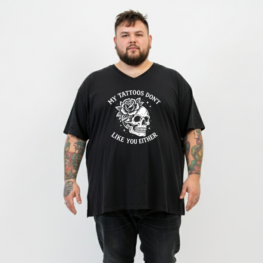 A man wearing black v neck graphic tee with My Tattoos Don't Like You Either skull and rose back print, plus size Australian streetwear by Bae Bands