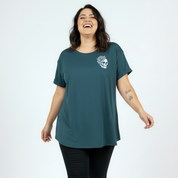 Front view of woman wearing teal My Tattoos Don't Like You Either oversized tee, relaxed drop shoulder fit, plus size Australian made streetwear by Bae Bands