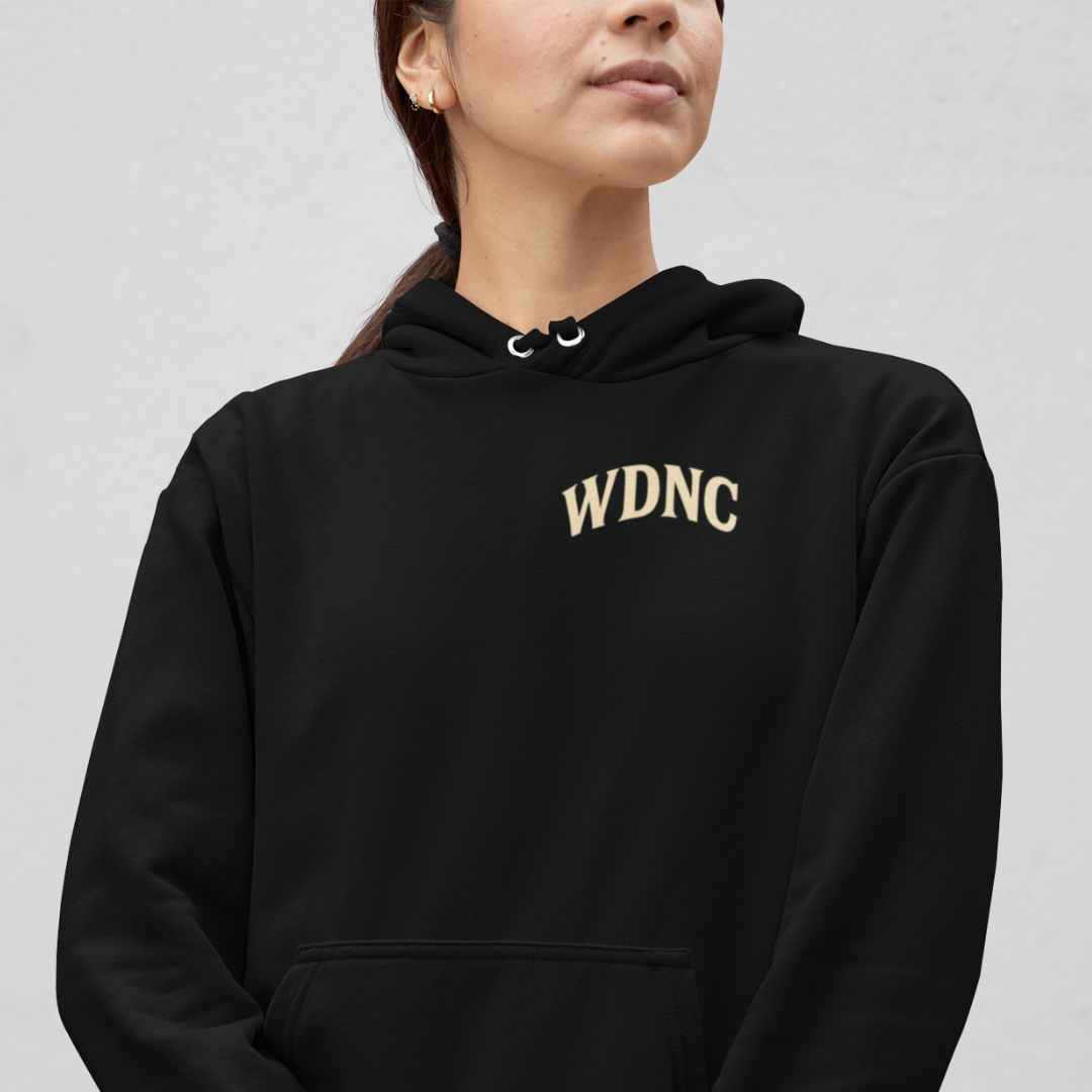 Black hoodie with skull, barbed wire and rose graphic under text “We Do Not Care Club” – plus-size streetwear hoodie