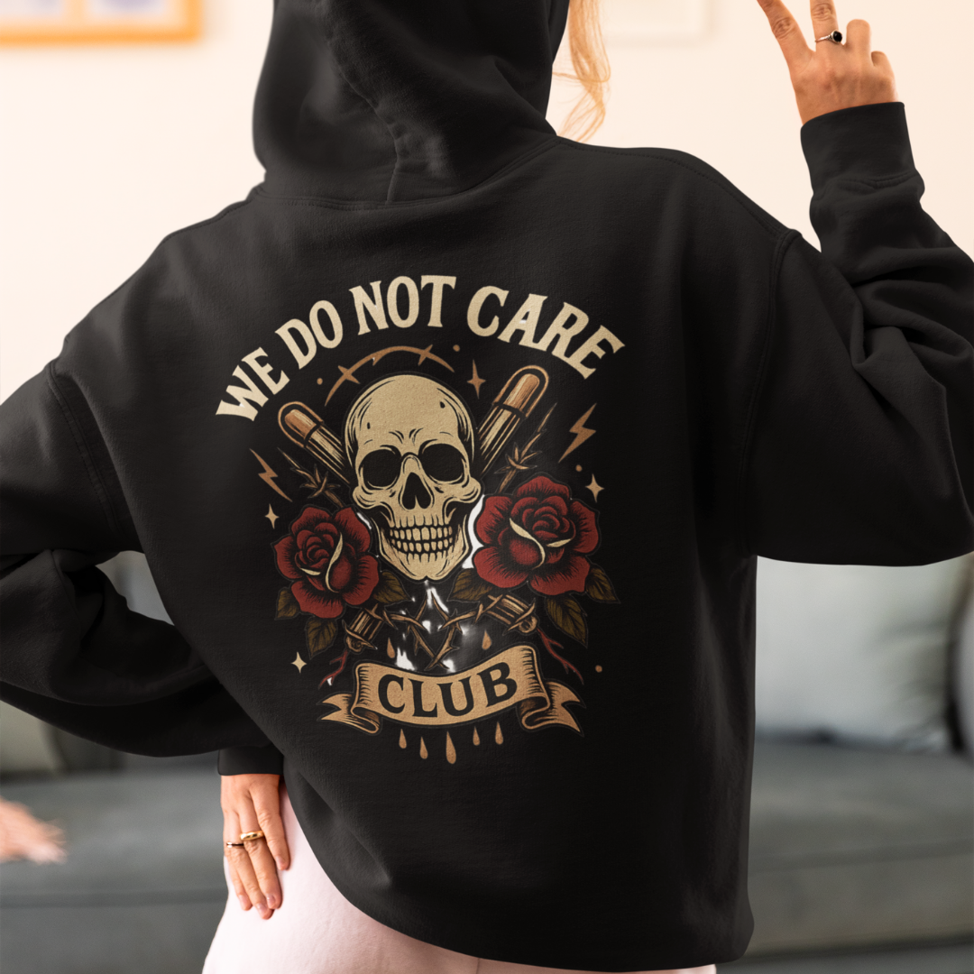 Unapologetic graphic hoodie with skull and roses print and bold “We Do Not Care Club” text – Bae Streetwear