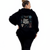 Back view of black Stay Weird hoodie showing full witchy illustrated grid with moth, mushrooms, tarot card and candle DTF print detail, relaxed plus size fit, Bae Bands Australia