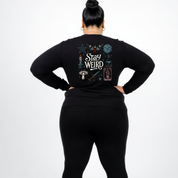Back view of black Stay Weird long sleeve tee showing full witchy illustrated grid with moth, mushrooms, tarot card and candle DTF print detail, relaxed plus size fit, Bae Bands Australia