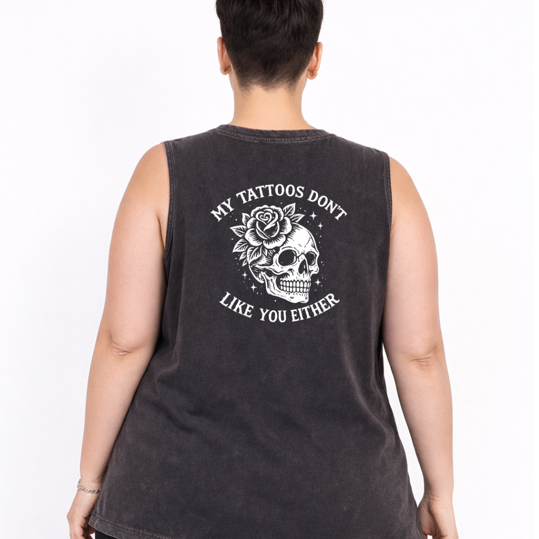 Woman wearing black stonewashed tank top with My Tattoos Don't Like You Either skull and rose back print, plus size Australian streetwear by Bae Bands