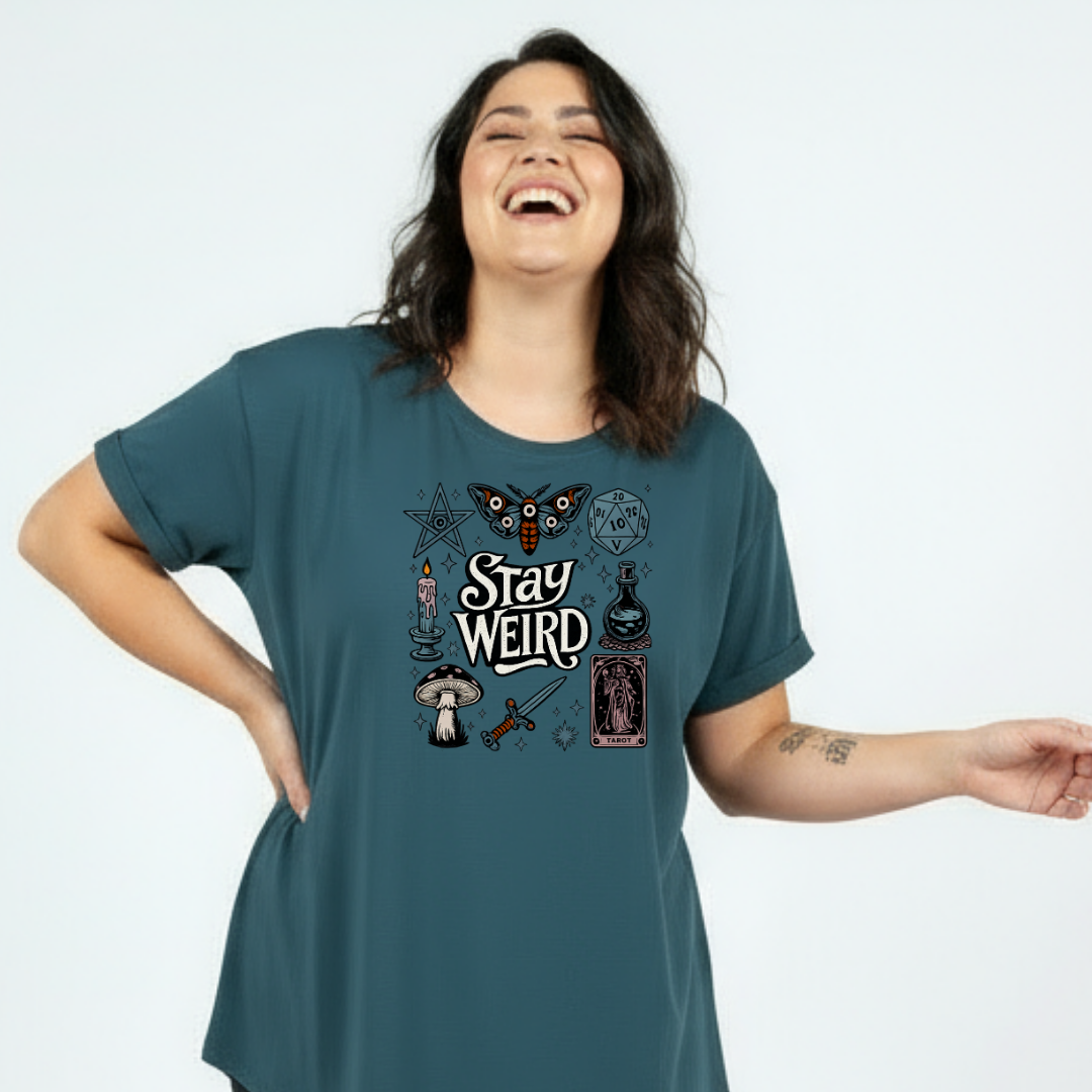 Front view of teal Stay Weird oversized tee showing full witchy illustrated grid with moth, mushrooms, tarot card and candle DTF print, Bae Bands Australia