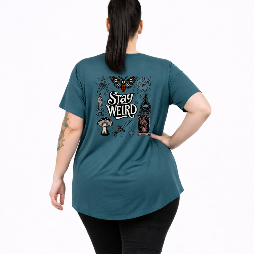 Woman wearing teal oversized graphic tee with Stay Weird witchy illustration back print, plus size Australian made streetwear by Bae Bands