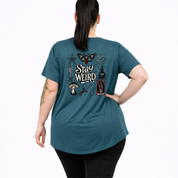 Woman wearing teal oversized graphic tee with Stay Weird witchy illustration back print, plus size Australian made streetwear by Bae Bands