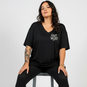 Back view of black Stay Weird v neck tee showing full witchy illustrated grid with moth, mushrooms, tarot card and candle DTF print, Bae Bands Australia
