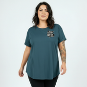 Front view of woman wearing teal Stay Weird oversized tee, relaxed drop shoulder fit, plus size Australian made streetwear by Bae Bands
