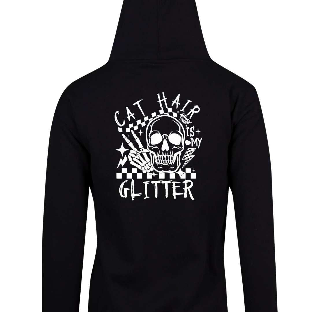 Black zip up hoodie back print of a skull with a skeleton hand reading Cat Hair Is My Glitter