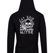 Black zip up hoodie back print of a skull with a skeleton hand reading Cat Hair Is My Glitter