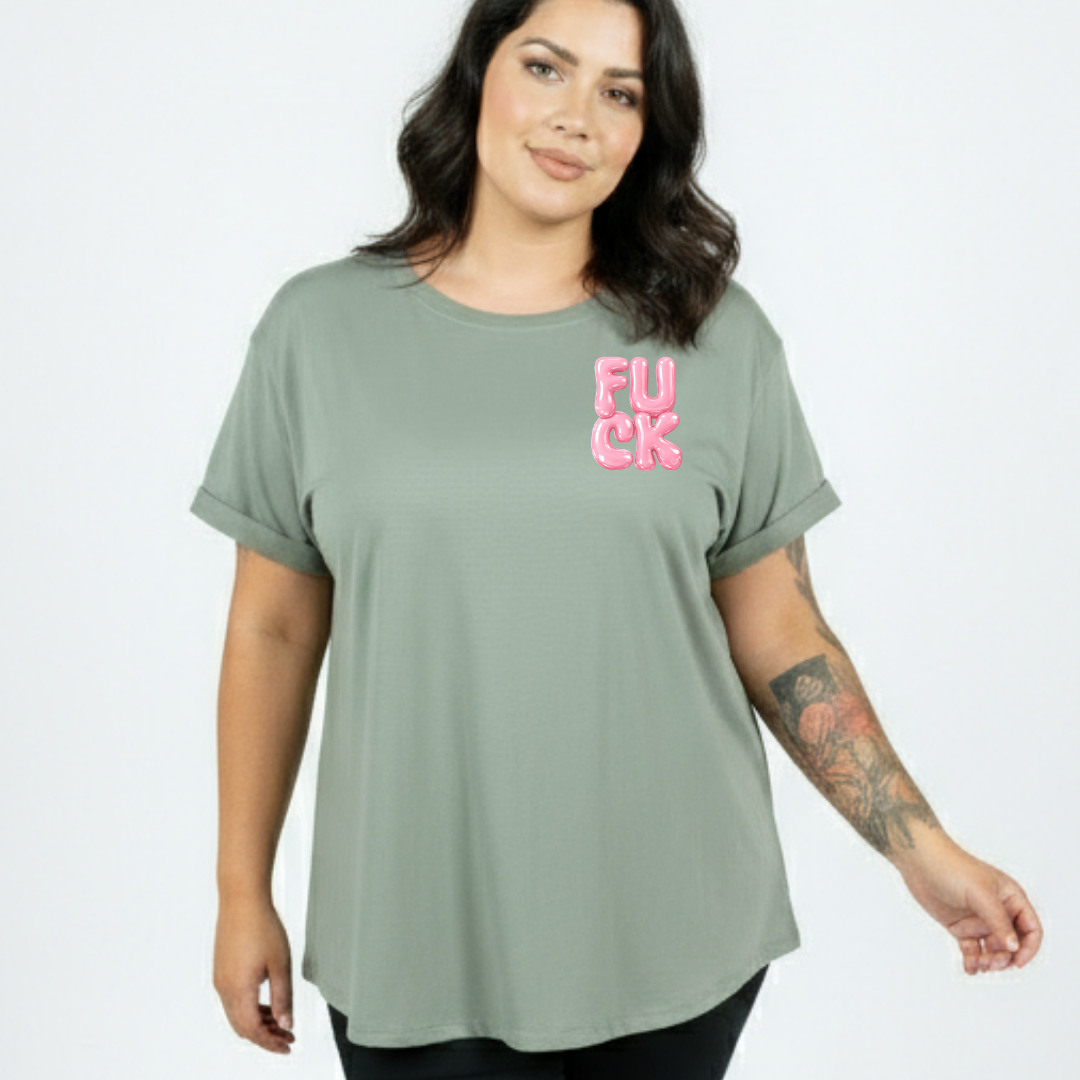 Woman wearing a green t-shirt with pink text on a plain background