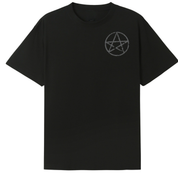 A black oversized tee with a small Village Witch graphic on the left chest.