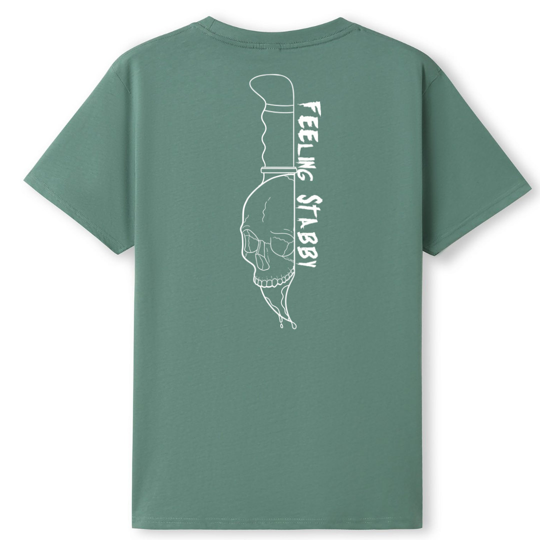 A slate green oversized tee shown from the back, with the Feeling Stabby graphic printed large across the back, a line drawn skull on a knife blade.