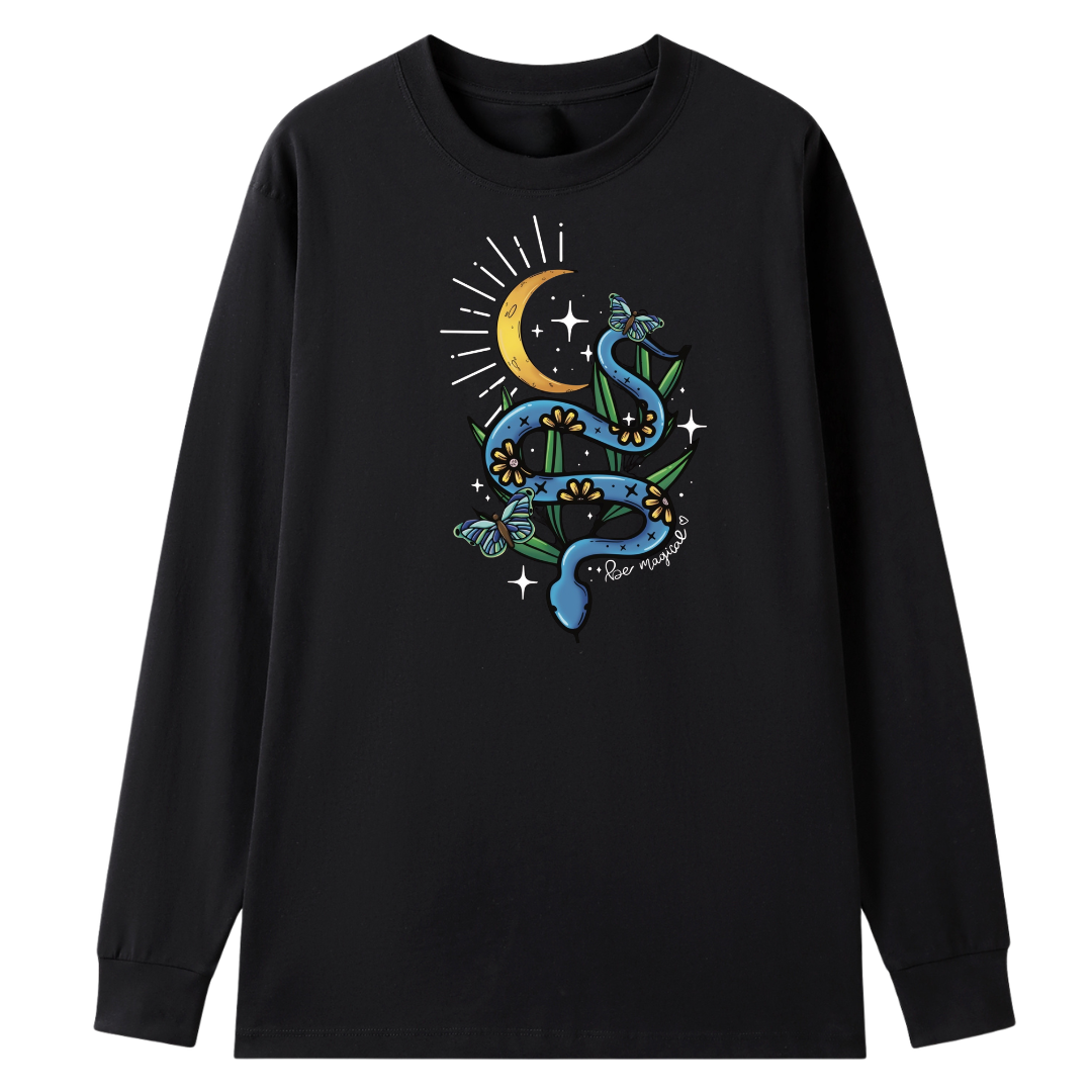 A black long sleeve tee with the Be Magic snake graphic printed large on the front, a blue floral snake with butterflies under a crescent moon.
