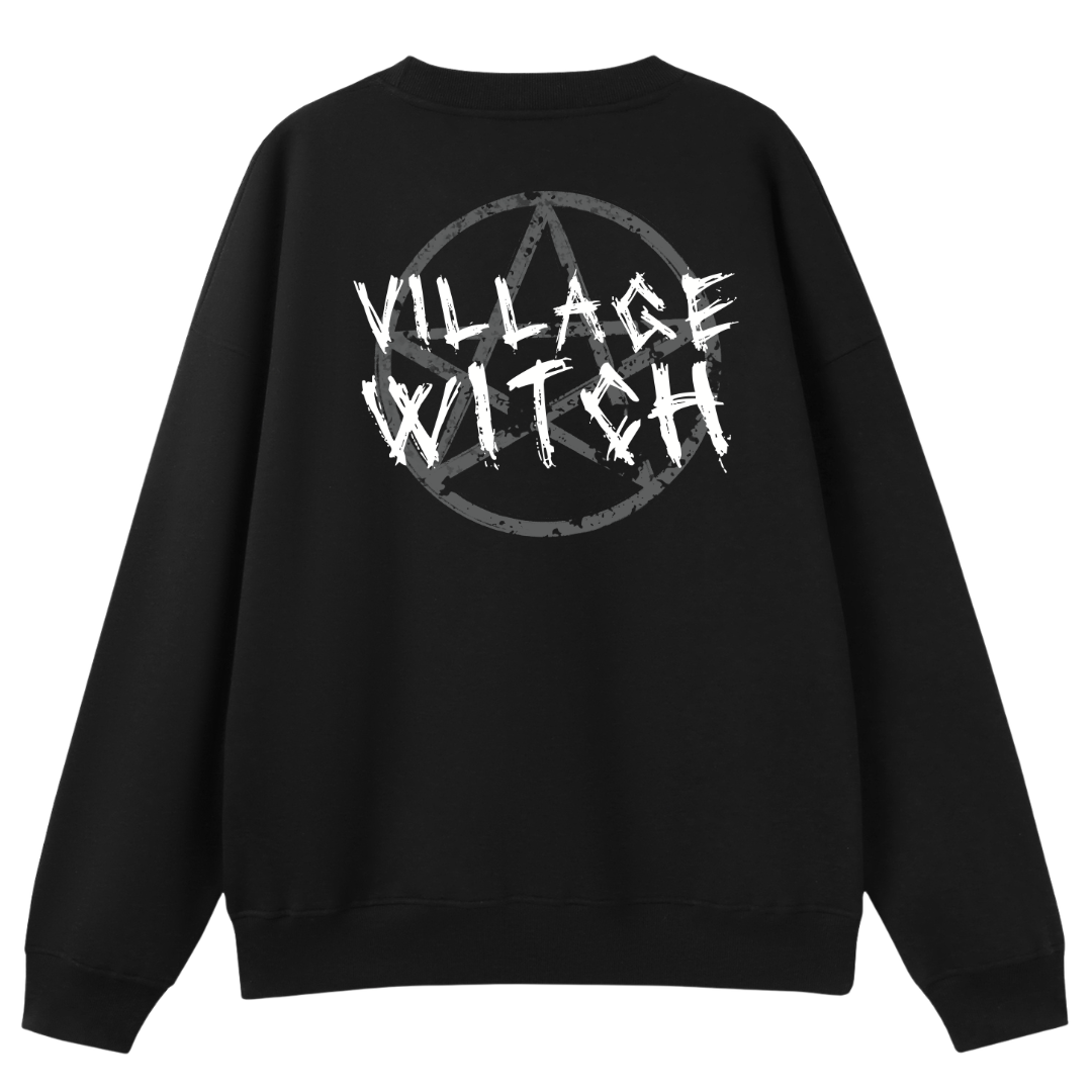 A black oversized crew neck shown from the back, with the Village Witch graphic printed large across the back, scratchy lettering over a weathered pentagram.