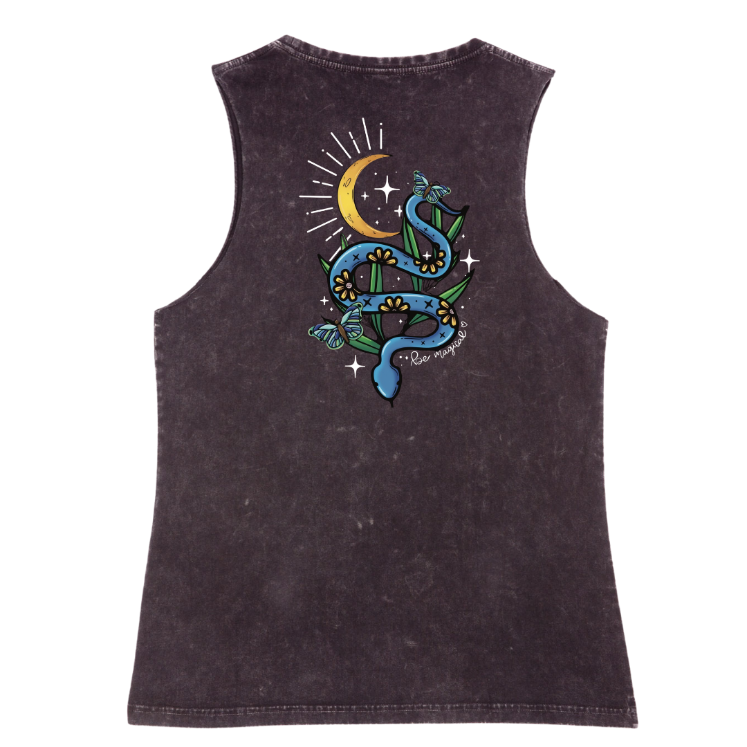 A black stone washed tank shown from the back, with the Be Magic snake graphic printed large across the back, a blue floral snake with butterflies under a crescent moon.