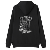 A black oversized hoodie shown from the back, with the We'll Come Back Again graphic printed large across the back, a crow on a tarot card framed by flowers.