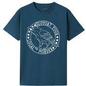 A teal oversized tee with the Support Your Local Murder graphic printed large on the front, a crow inside a circular badge.