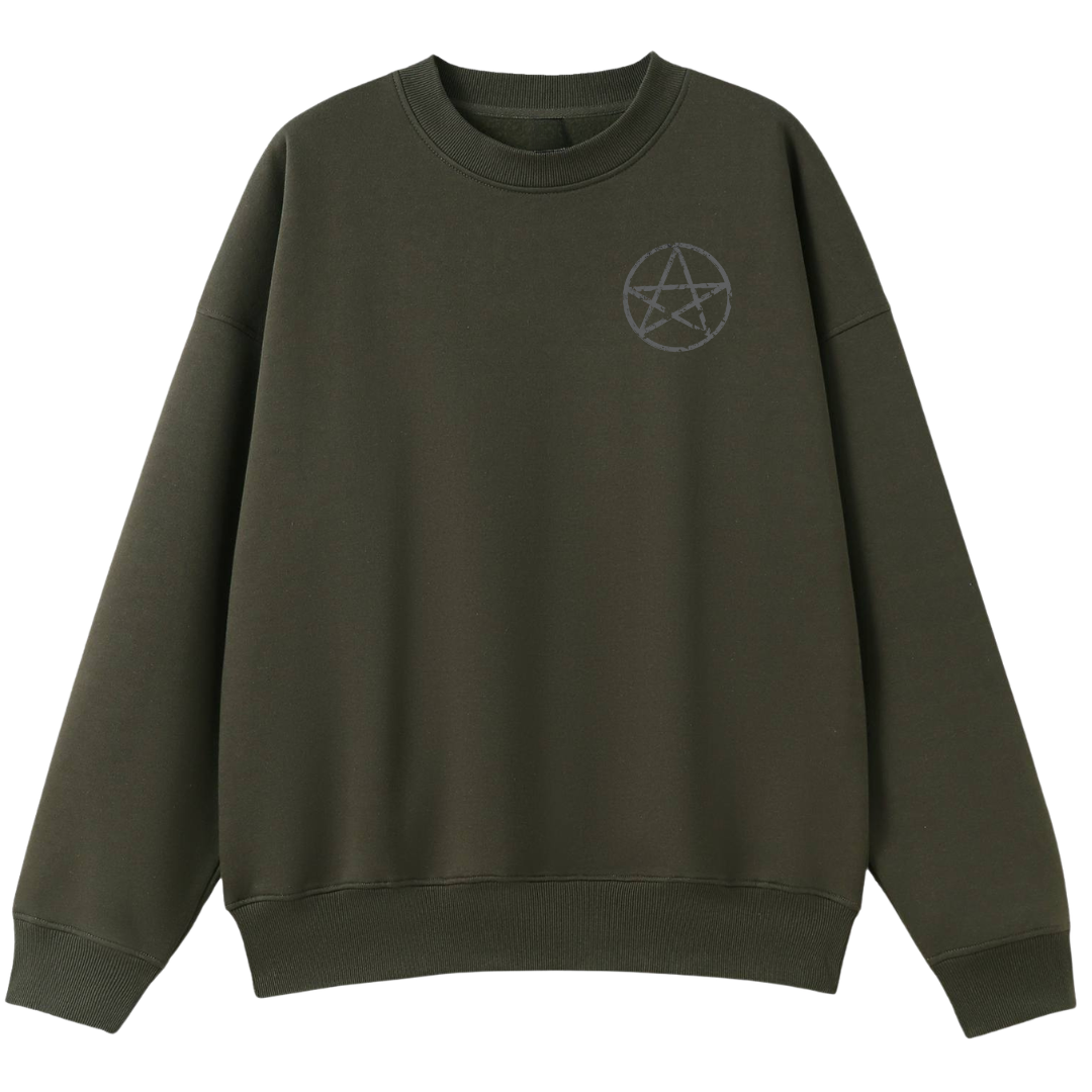 An army green oversized crew neck with a small Village Witch graphic on the left chest.