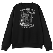 A black oversized crew neck with the We'll Come Back Again graphic printed large on the front, a crow on a tarot card framed by flowers.