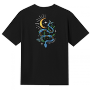 A black V neck oversized tee shown from the back, with the Be Magic snake graphic printed large across the back, a blue floral snake with butterflies under a crescent moon.