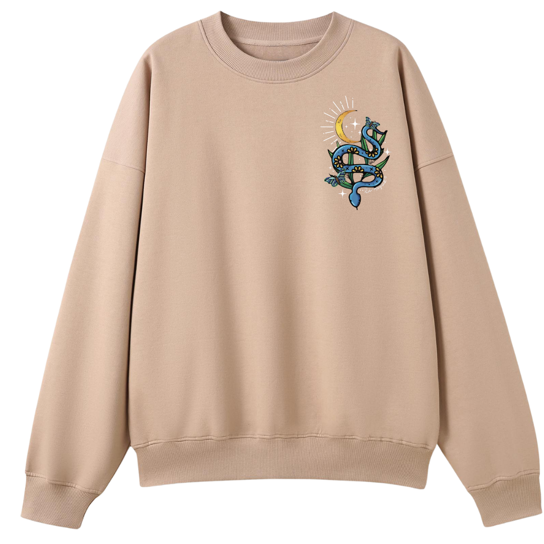 A peach oversized crew neck with a small Be Magic snake graphic on the left chest.