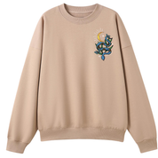 A peach oversized crew neck with a small Be Magic snake graphic on the left chest.