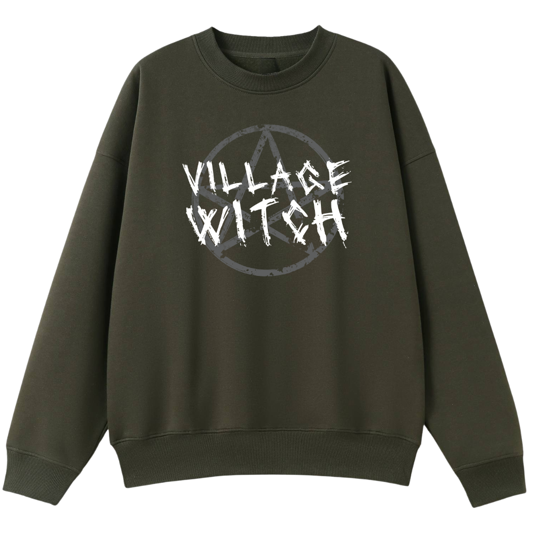 An army green oversized crew neck with the Village Witch graphic printed large on the front, scratchy lettering over a weathered pentagram.