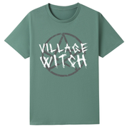 A slate green oversized tee with the Village Witch graphic printed large on the front, scratchy lettering over a weathered pentagram.