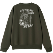 An army green oversized crew neck shown from the back, with the We'll Come Back Again graphic printed large across the back, a crow on a tarot card framed by flowers.