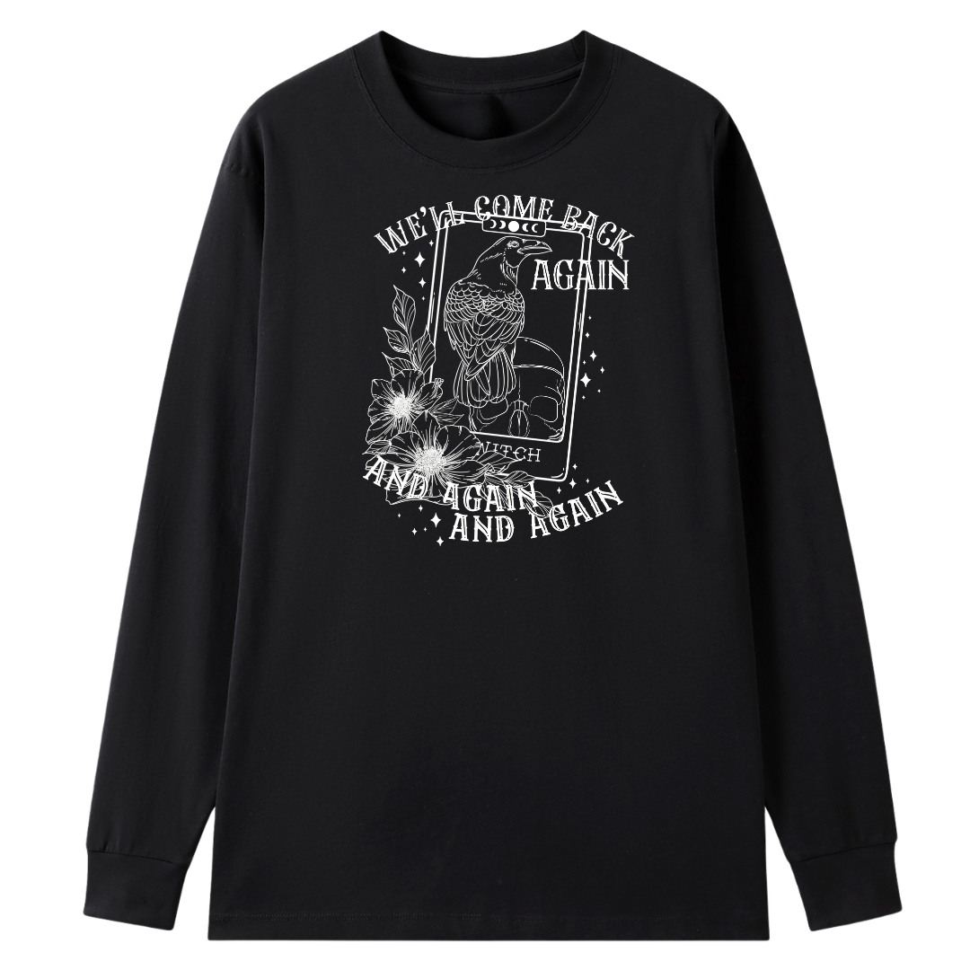 A black long sleeve tee with the We'll Come Back Again graphic printed large on the front, a crow on a tarot card framed by flowers.
