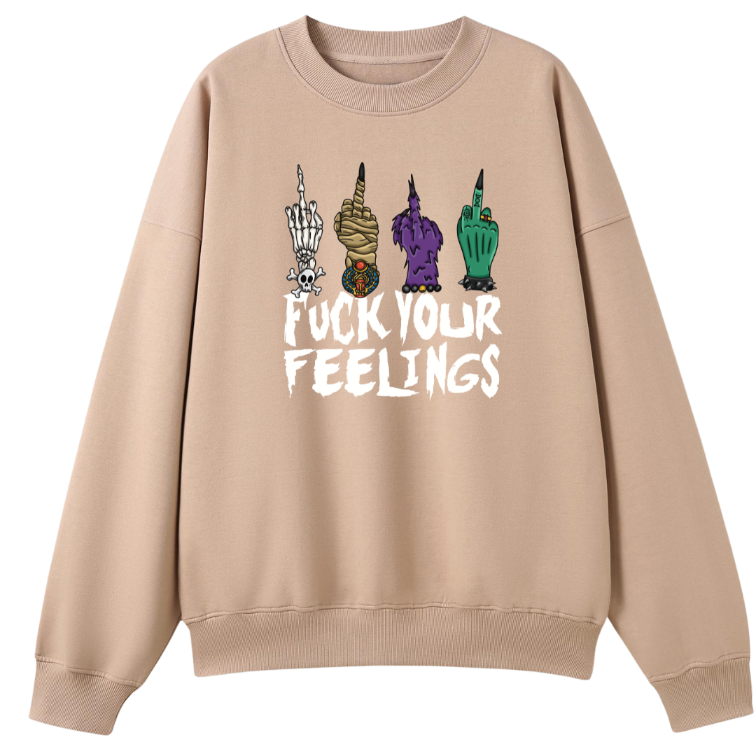 A peach oversized crew neck with the Fuck Your Feelings graphic printed large on the front, skeleton, mummy, werewolf and witch hands flipping the bird.