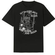 A black oversized tee with the We'll Come Back Again graphic printed large on the front, a crow on a tarot card framed by flowers.