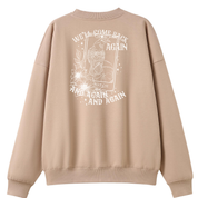 A peach oversized crew neck shown from the back, with the We'll Come Back Again graphic printed large across the back, a crow on a tarot card framed by flowers.