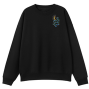 A black oversized crew neck with a small Be Magic snake graphic on the left chest.