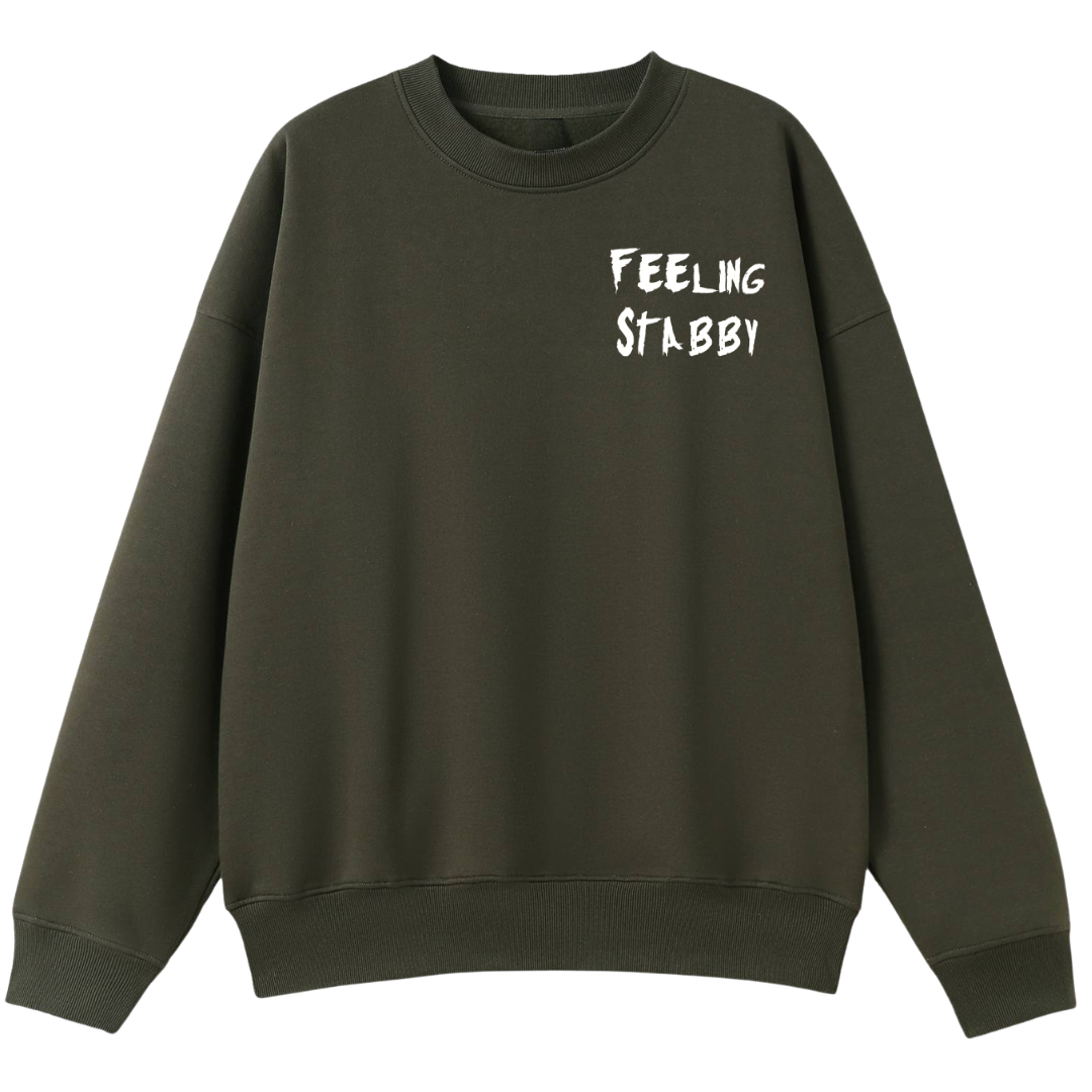 An army green oversized crew neck with a small Feeling Stabby graphic on the left chest.
