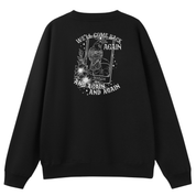 A black oversized crew neck shown from the back, with the We'll Come Back Again graphic printed large across the back, a crow on a tarot card framed by flowers.