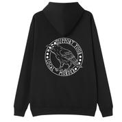 A black oversized hoodie shown from the back, with the Support Your Local Murder graphic printed large across the back, a crow inside a circular badge.