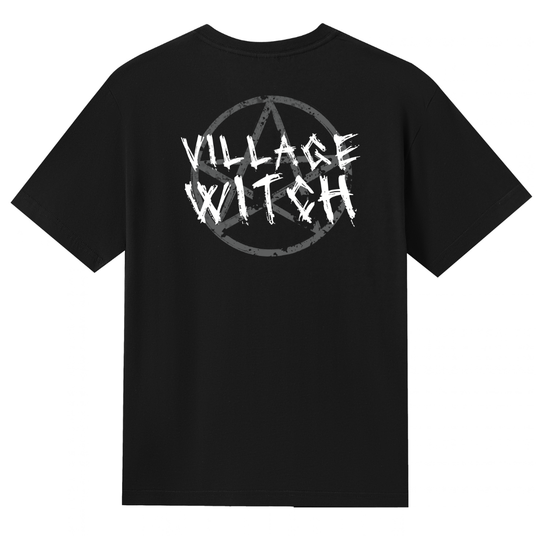 A black V neck oversized tee shown from the back, with the Village Witch graphic printed large across the back, scratchy lettering over a weathered pentagram.