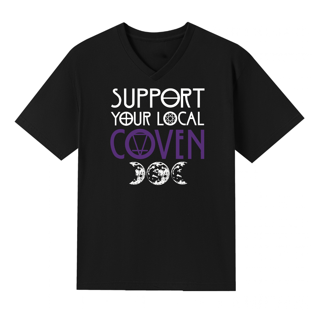 A black V neck oversized tee with the Support Your Local Coven graphic printed large on the front, purple lettering above a triple moon.