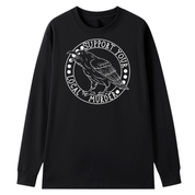 A black long sleeve tee with the Support Your Local Murder graphic printed large on the front, a crow inside a circular badge.