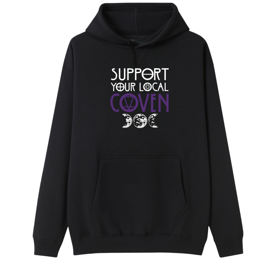 A black oversized hoodie with the Support Your Local Coven graphic printed large on the front, purple lettering above a triple moon.