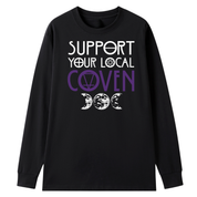A black long sleeve tee with the Support Your Local Coven graphic printed large on the front, purple lettering above a triple moon.