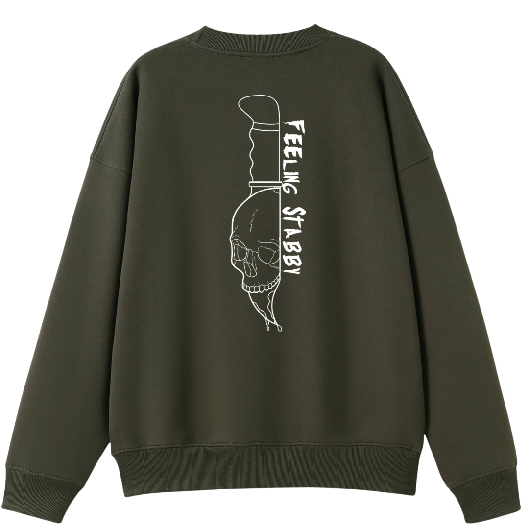 An army green oversized crew neck shown from the back, with the Feeling Stabby graphic printed large across the back, a line drawn skull on a knife blade.